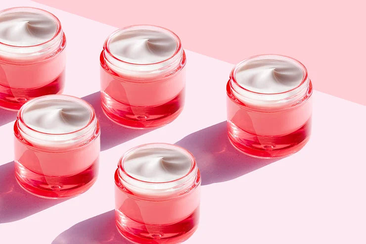 Five red cosmetic jars filled with white cream